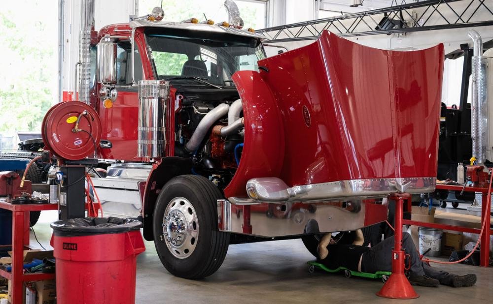 Mechanic checking a truck wheel during inspection