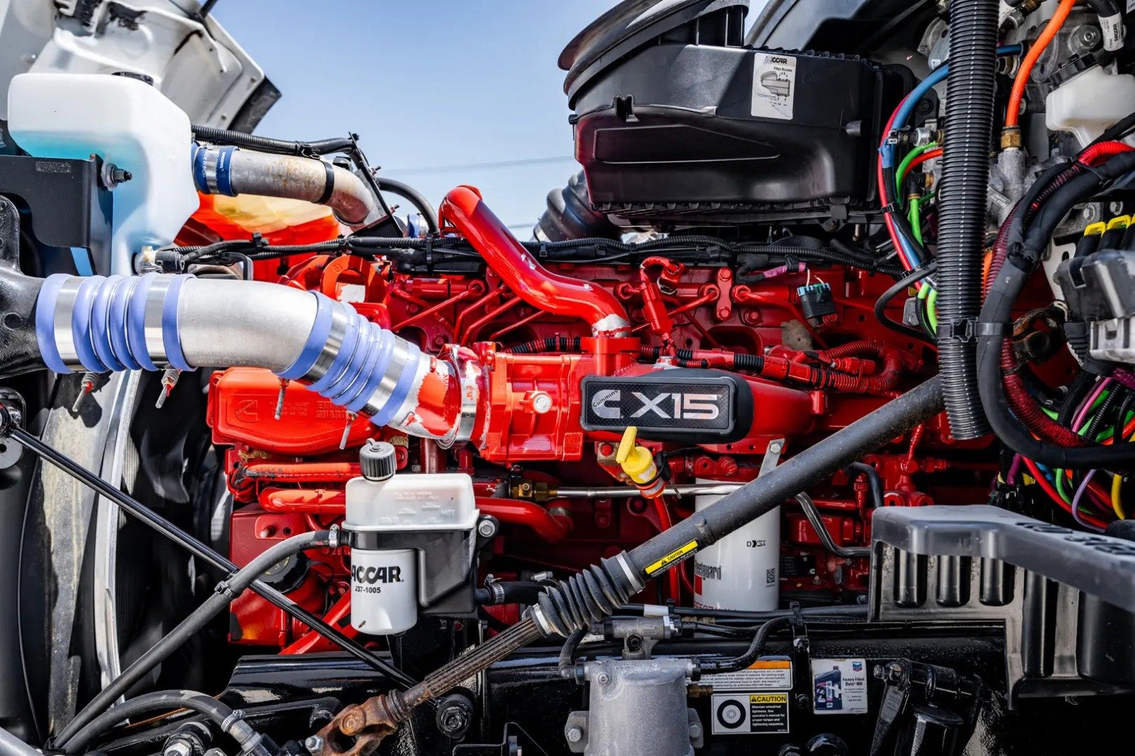 Mechanic inspecting an engine in a dimly lit garage