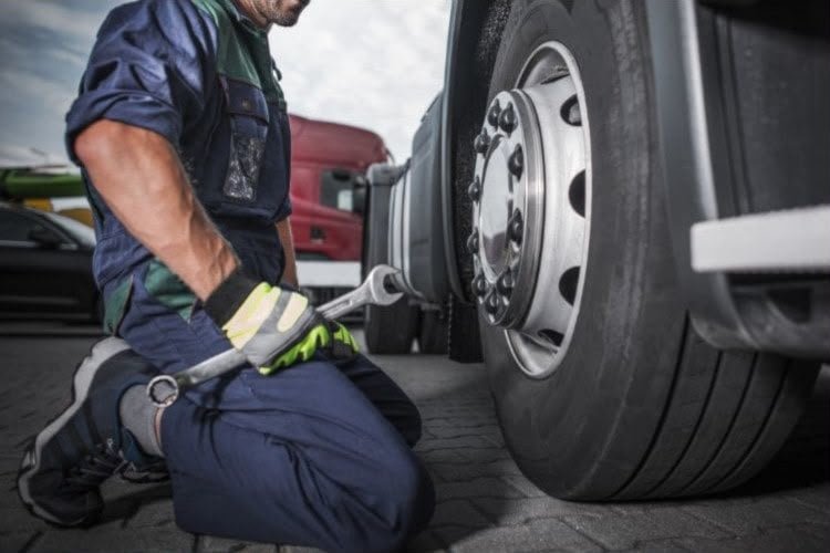 Heavy truck tire being serviced