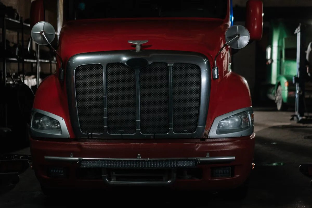 Semi truck in a dimly lit repair garage
